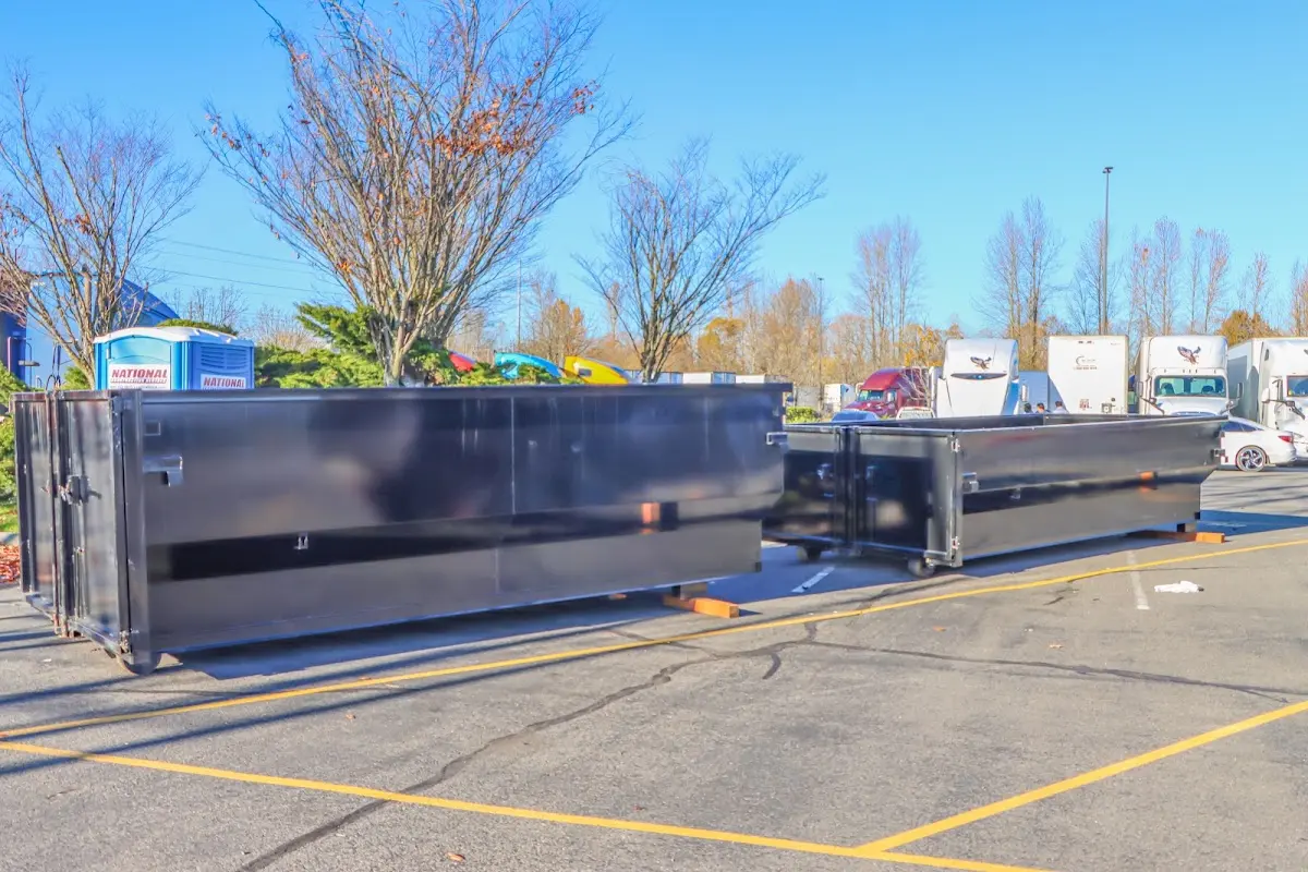 Professional dumpster rental service with roll-off container on residential driveway in Franklin Town